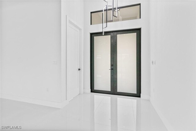 845 SW 15th Ter, Cape Coral, FL 33991 - foyer with baseboards, a chandelier, and tile patterned floors