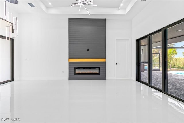 845 SW 15th Ter, Cape Coral, FL 33991 - interior space with tile patterned floors, a tray ceiling, a large fireplace, and visible vents