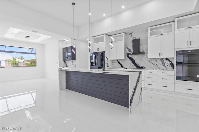 845 SW 15th Ter, Cape Coral, FL 33991 - kitchen featuring backsplash, a sink, black appliances, white cabinetry, and an island with sink