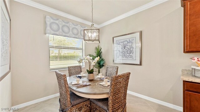 3524 Stormy Creek Ln, Alva, FL 33920 - dining space featuring crown molding, light tile patterned flooring, baseboards, and an inviting chandelier