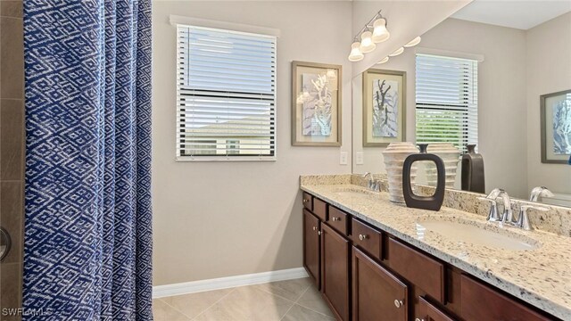 3524 Stormy Creek Ln, Alva, FL 33920 - bathroom with a sink, baseboards, tile patterned flooring, and double vanity