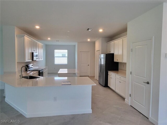 3524 Stormy Creek Ln, Alva, FL 33920 - kitchen with white cabinets, appliances with stainless steel finishes, visible vents, and light countertops