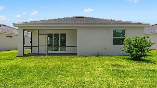 3036 Weston Manor Dr, Alva, FL 33920 - rear view of house with a sunroom, stucco siding, and a yard