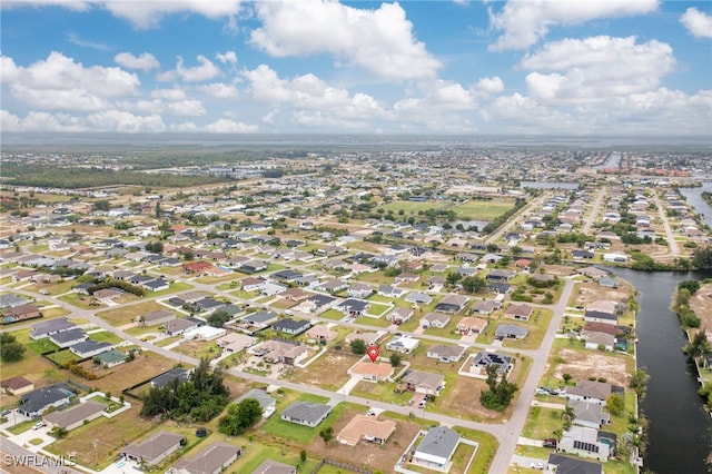 aerial overview of property's location featuring nearby suburban area and a nearby body of water