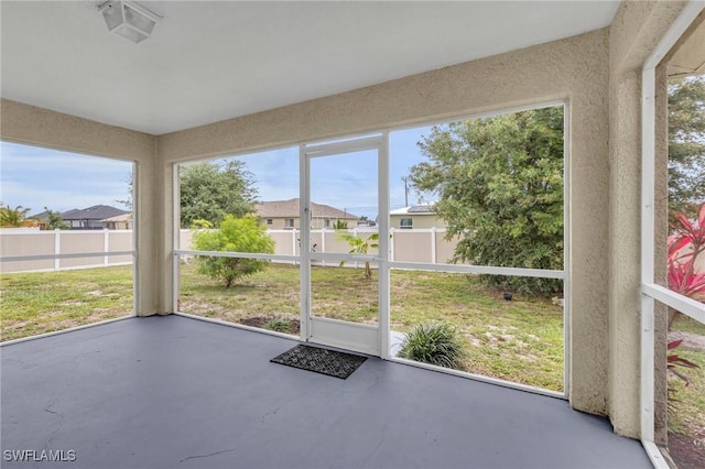 unfurnished sunroom featuring a residential view