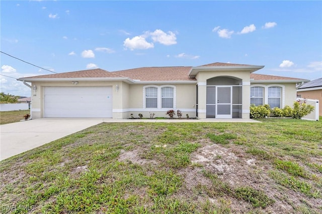 single story home featuring stucco siding, a garage, driveway, and a front lawn