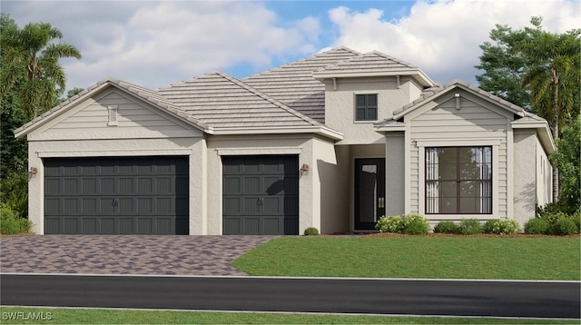 view of front of home with driveway, a tile roof, a front yard, a garage, and stucco siding