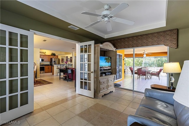 living area featuring ceiling fan, french doors, light tile patterned flooring, and visible vents