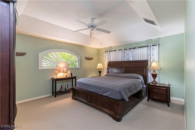 bedroom featuring baseboards, a ceiling fan, light colored carpet, and visible vents