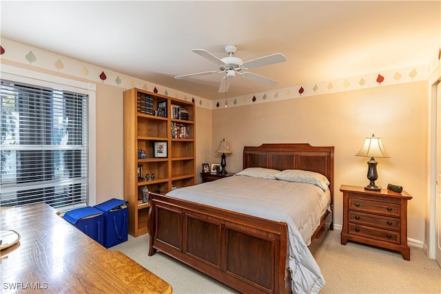 bedroom featuring baseboards, ceiling fan, and light carpet