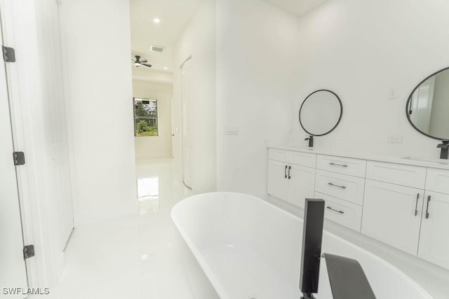 1412 5th Ave, Lehigh Acres, FL 33972 - bathroom featuring a freestanding tub, double vanity, and recessed lighting