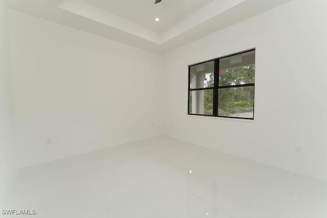 1412 5th Ave, Lehigh Acres, FL 33972 - spare room featuring recessed lighting and a tray ceiling
