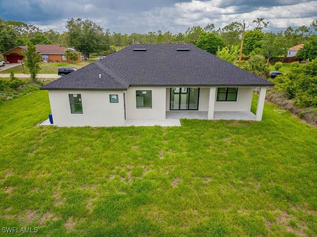 1412 5th Ave, Lehigh Acres, FL 33972 - rear view of property with roof with shingles, a patio area, stucco siding, and a lawn