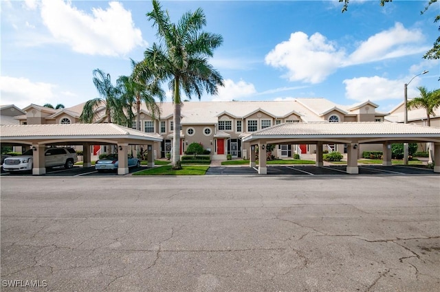 13641 Worthington Way Unit 1612, Bonita Springs, FL 34135 - view of building exterior featuring covered parking and a residential view