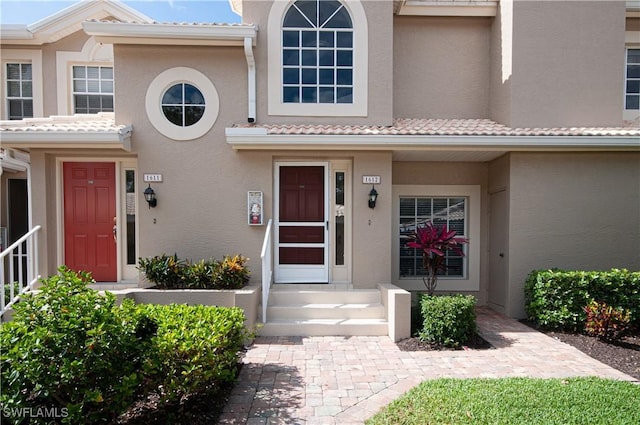 13641 Worthington Way Unit 1612, Bonita Springs, FL 34135 - property entrance with stucco siding and a tiled roof