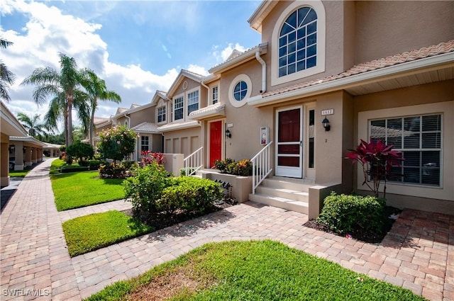 13641 Worthington Way Unit 1612, Bonita Springs, FL 34135 - view of front of property featuring stucco siding and a front yard