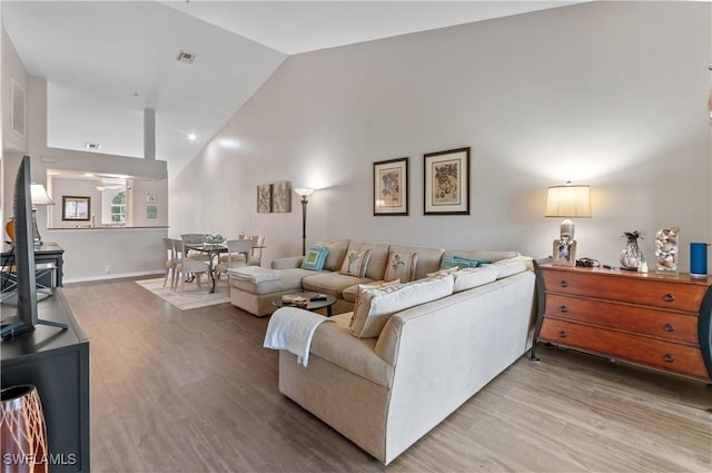13641 Worthington Way Unit 1612, Bonita Springs, FL 34135 - living area with lofted ceiling, a wood stove, and light wood-style flooring