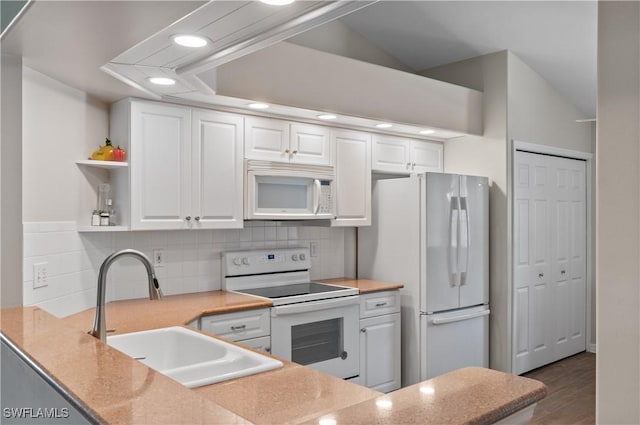 13641 Worthington Way Unit 1612, Bonita Springs, FL 34135 - kitchen with white appliances, white cabinetry, recessed lighting, and decorative backsplash