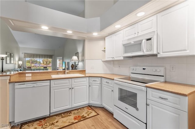 13641 Worthington Way Unit 1612, Bonita Springs, FL 34135 - kitchen featuring white appliances, light wood finished floors, white cabinetry, vaulted ceiling, and open floor plan