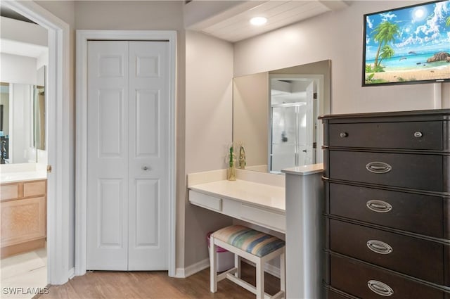 13641 Worthington Way Unit 1612, Bonita Springs, FL 34135 - full bathroom with a closet, vanity, wood finished floors, and a stall shower