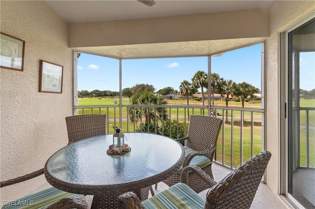 13641 Worthington Way Unit 1612, Bonita Springs, FL 34135 - sunroom featuring a textured wall, view of golf course, healthy amount of natural light, and a ceiling fan