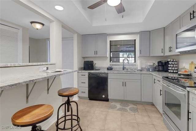 3720 SE 10th Ave Unit 102, Cape Coral, FL 33904 - kitchen featuring a ceiling fan, dishwasher, a sink, electric stove, and a tray ceiling