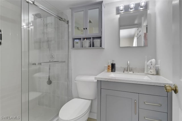 3720 SE 10th Ave Unit 102, Cape Coral, FL 33904 - bathroom featuring toilet, a shower stall, and vanity