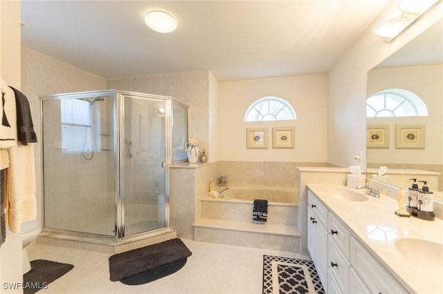full bathroom with a garden tub, a sink, tile patterned floors, and a shower stall