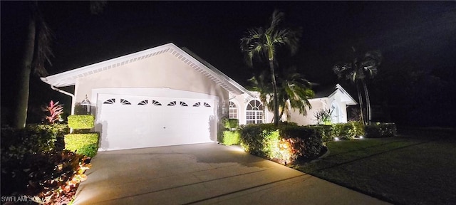 ranch-style house with an attached garage and driveway