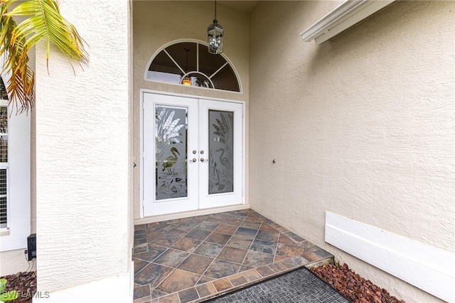 doorway to property with french doors and stucco siding