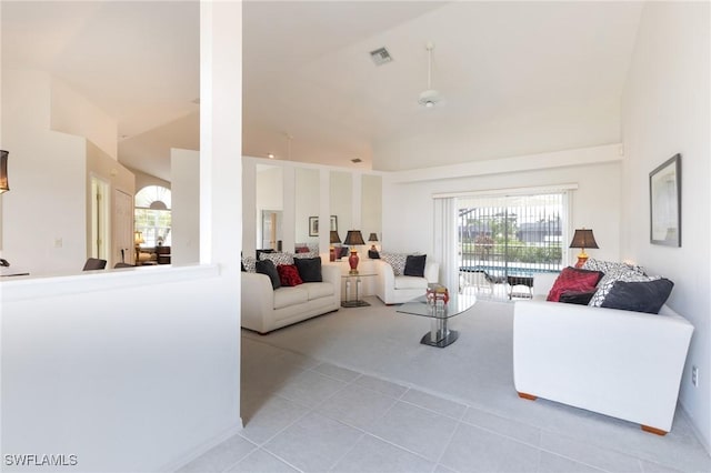 living room with light colored carpet, visible vents, plenty of natural light, and light tile patterned floors