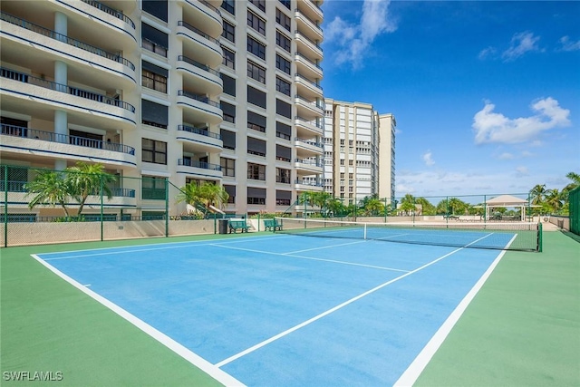 view of sport court featuring fence