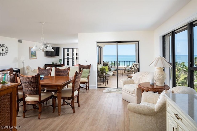 dining area featuring visible vents and light wood-style flooring