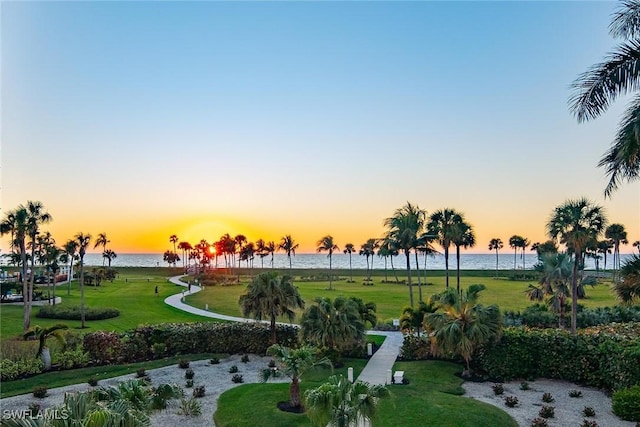 view of home's community featuring a water view and a yard
