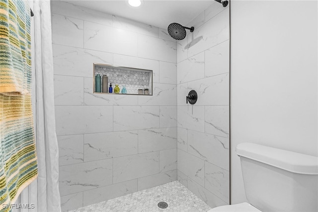 full bath with a shower stall and toilet