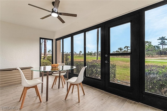 sunroom / solarium featuring a wealth of natural light, french doors, and wood finished floors