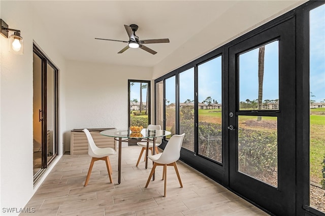 sunroom featuring french doors, wood finished floors, and a wealth of natural light