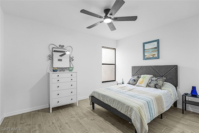 bedroom with baseboards and wood finished floors