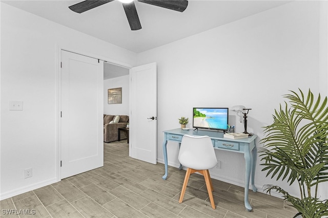 office area with baseboards, a ceiling fan, and wood finish floors