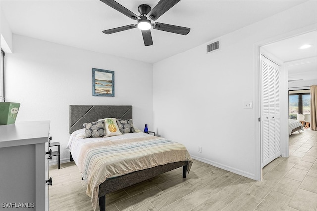 bedroom featuring visible vents, light wood finished floors, ceiling fan, and baseboards