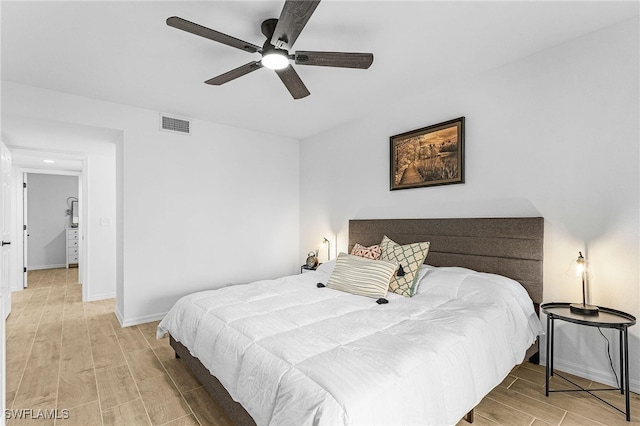 bedroom featuring visible vents, baseboards, ceiling fan, and wood finish floors