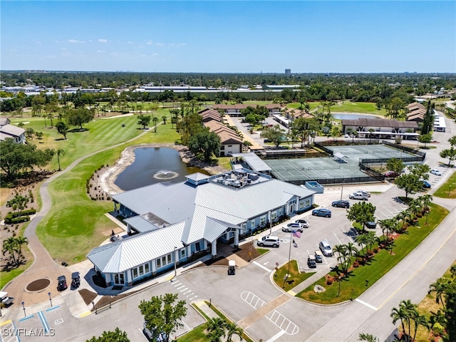 drone / aerial view with a water view and golf course view