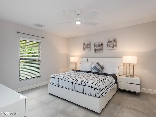 bedroom with ceiling fan, baseboards, visible vents, and light tile patterned floors