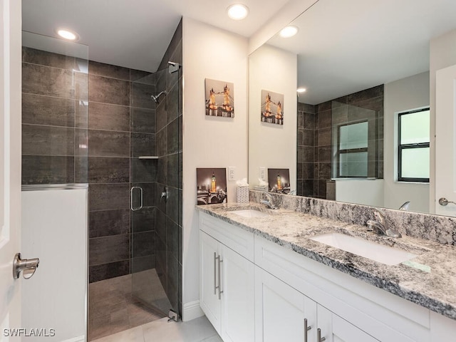 full bath featuring recessed lighting, a tile shower, and a sink