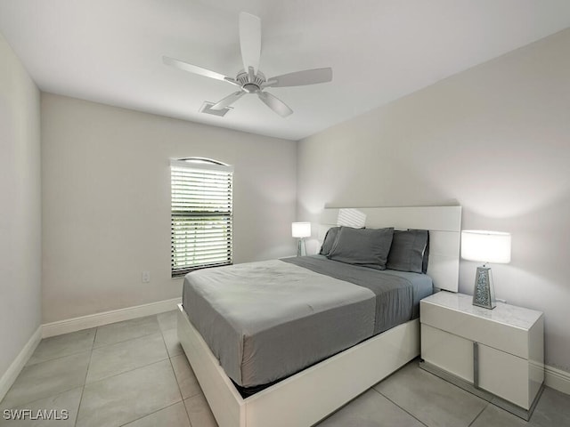bedroom featuring baseboards, ceiling fan, and light tile patterned floors