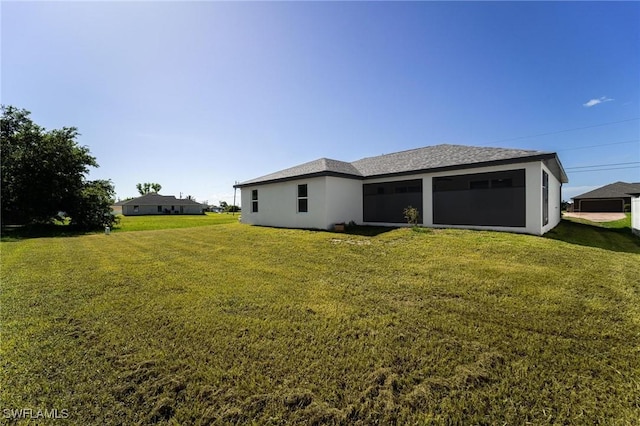 403 NW 17th Ter, Cape Coral, FL 33993 - rear view of property with a yard, a sunroom, and stucco siding
