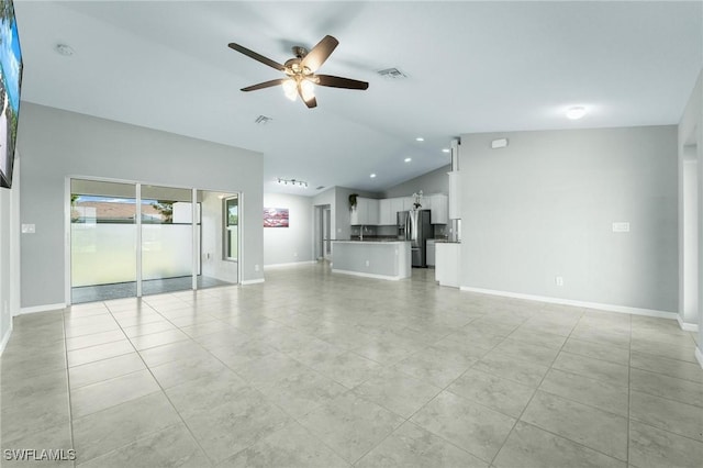 403 NW 17th Ter, Cape Coral, FL 33993 - unfurnished living room with baseboards, ceiling fan, lofted ceiling, and light tile patterned floors