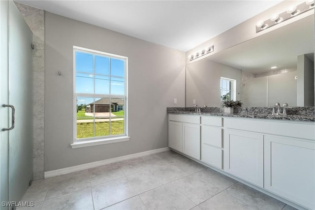 403 NW 17th Ter, Cape Coral, FL 33993 - bathroom featuring a healthy amount of sunlight, double vanity, a stall shower, and a sink