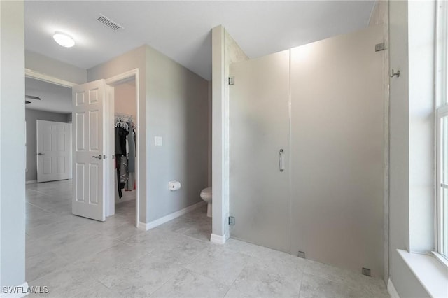 403 NW 17th Ter, Cape Coral, FL 33993 - bathroom with visible vents, toilet, baseboards, a spacious closet, and a stall shower