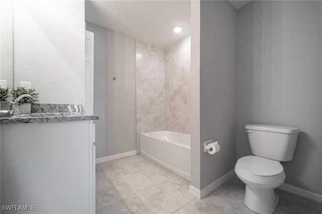 403 NW 17th Ter, Cape Coral, FL 33993 - full bath featuring washtub / shower combination, tile patterned flooring, vanity, toilet, and baseboards